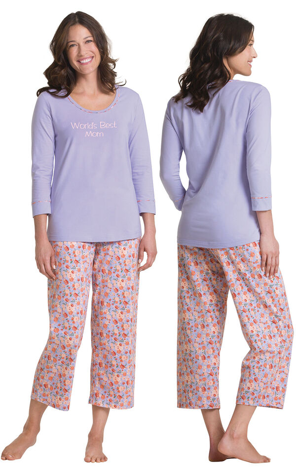 Model wearing Solid Lavender 3/4-sleeve top with Lavender floral print capris pajamas, facing away from the camera and then facing to the side image number 1
