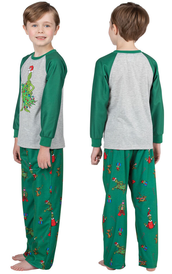 Model wearing Dr. Seuss' The Grinch Boys Pajamas, facing away from the camera and then to the side