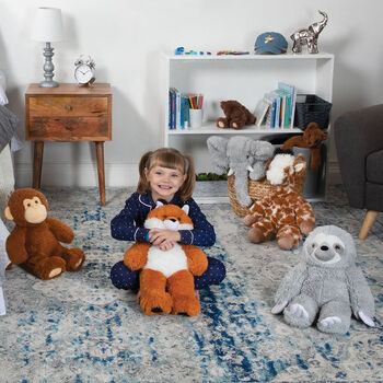 18" Oh So Soft Giraffe - 18" Elephant, 18" Giraffe, 18" Sloth, 18" Monkey, and 18" Fox sitting on the floor in a bedroom with a child in pajamas