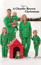 Family standing around doghouse, all wearing Green Charlie Brown Matching Christmas Pajamas image number 1