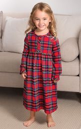 Toddler girl standing by couch wearing Steward Plaid Flannel Toddler Nighty image number 4