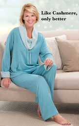 Model wearing Teal World's Softest Pajamas sitting on a couch with the following copy: Like Cashmere, only better image number 4