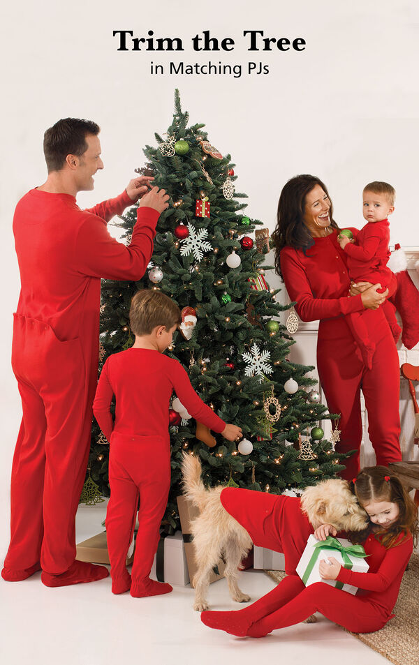Family trimming the Christmas tree in matching Red Dropseat PJs image number 1