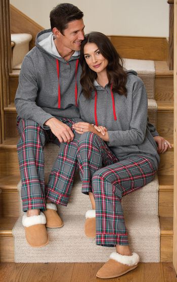 Couple sitting down wearing matching His and Hers Gray Plaid Hooded Pajamas