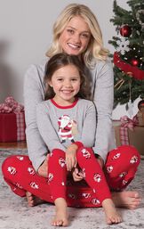 Mom and Toddler wearing matching gray and red St. Nick Pajamas, sitting by Christmas Tree image number 5