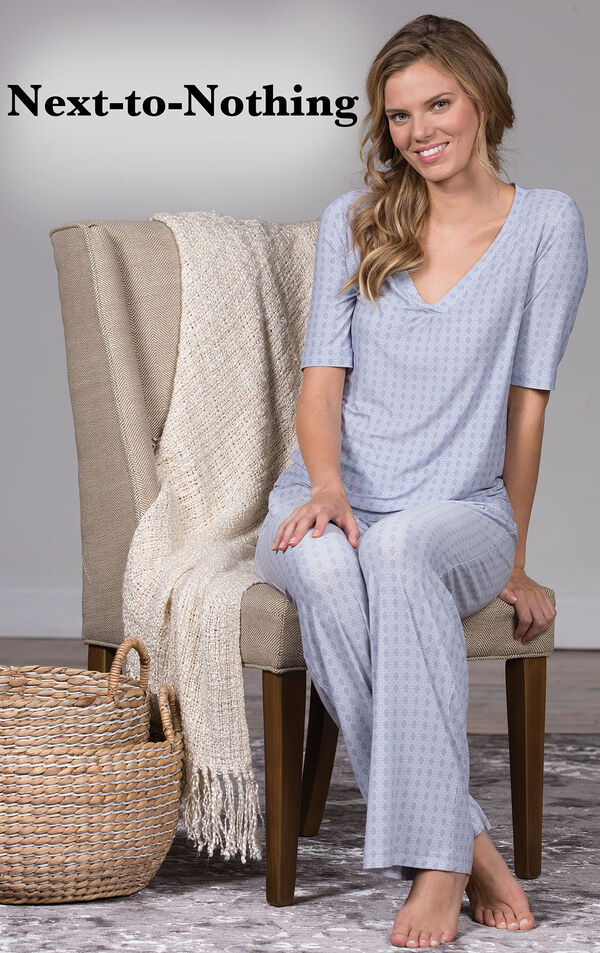 Model sitting on a chair wearing Nudies Pajamas - Blue with the following c...