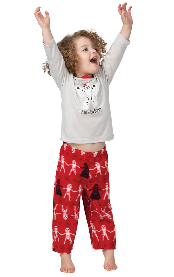 Toddler with his arms waiving in excitement wearing Red Star Wars Pajamas with "Up To Snow Good" printed on the top