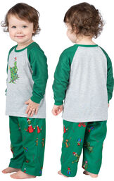 Infant wearing green and gray Dr. Seuss' The Grinch™ Pajamas, facing away from the camera and then facing to the side image number 1