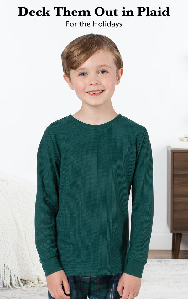 Boy wearing Heritage Plaid Thermal-Top Pajamas by bed with the following copy: Deck them out in plaid for the holidays image number 2
