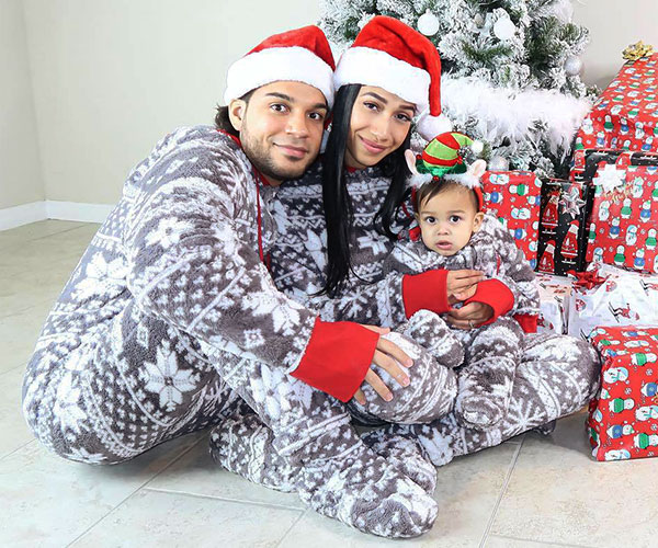 An image of a family wearing matching Nordic Hoodie-Footie pajamas