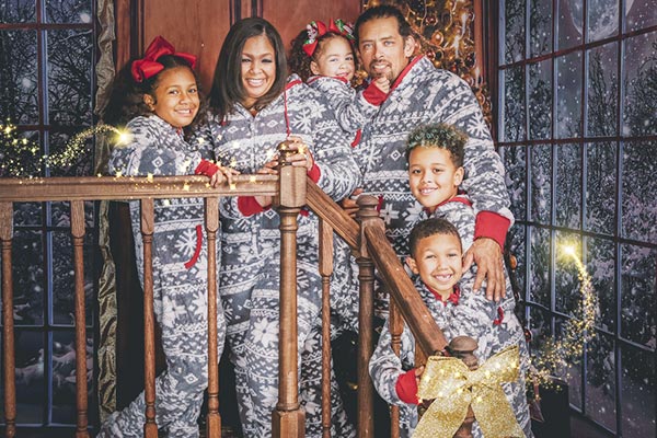 A large family together wearing matching PajamaGram Nordic Hoodie-Footie pajamas