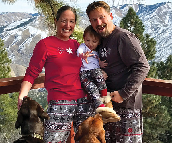A family standing on a balcony wearing PajamaGram Nordic matching family pajamas