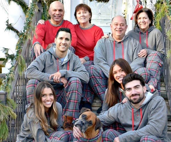 A large family posing together ourdoors, all wearing PajamaGram Gray Plaid matching family pamajas